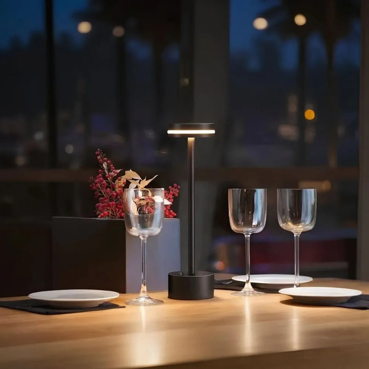 Stylish cordless aluminum table lamp providing ambient lighting; "Cosmic Elegance" model.