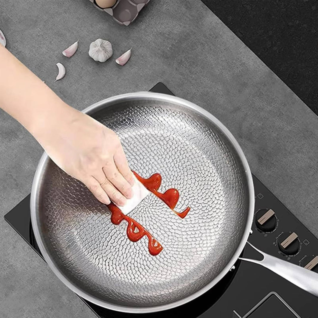 Deep-sided non-stick titanium frying pan. Durable, induction-ready kitchen essential for versatile cooking.