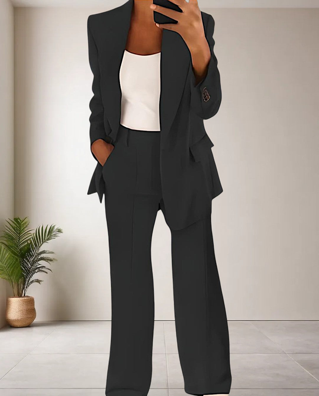Women's two-piece pantsuit featuring a stylish blazer and coordinating trousers. Perfect for office & casual wear.