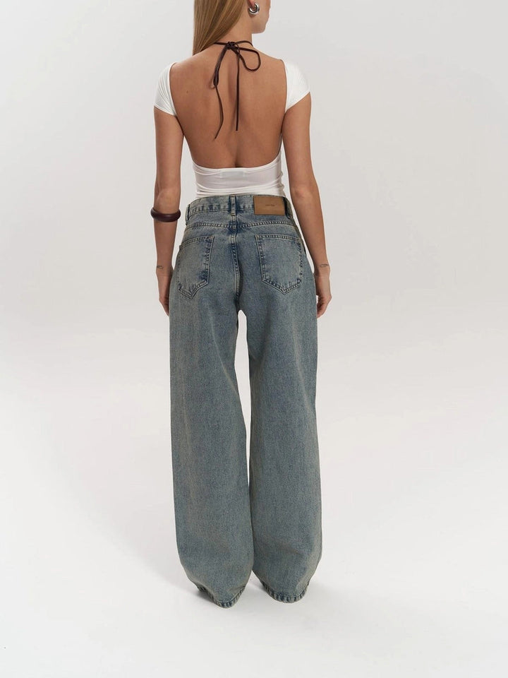 Statement women's high waist wide leg jeans featuring unique mesh panels for a trendy, modern look. Casual blue denim.