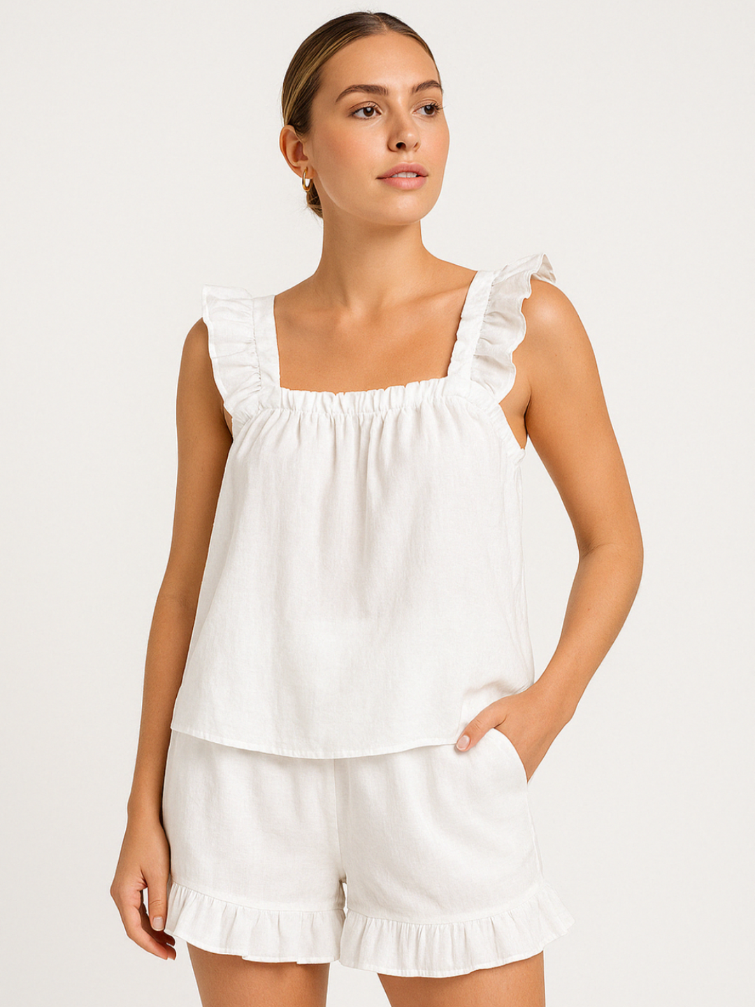 Women's ruffle pajama set, sleeveless top & shorts. Perfect for warm summer nights & comfortable lounging.