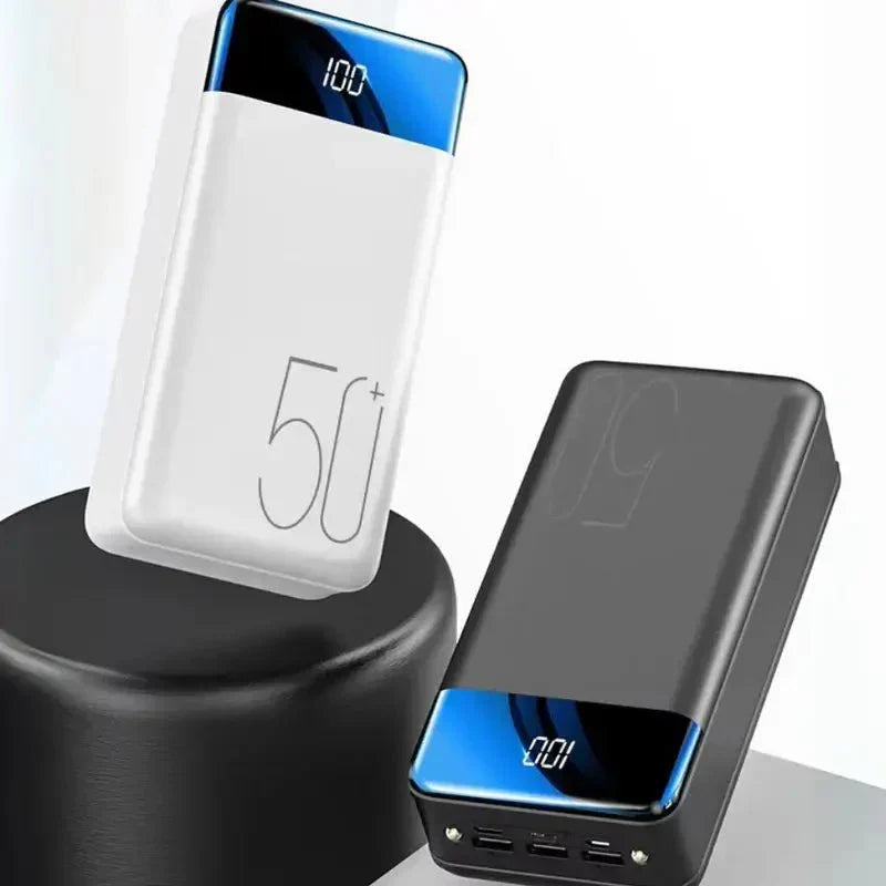 Unisex 50000mAh power bank charging a smartphone, featuring multiple fast-charging USB ports for travel.