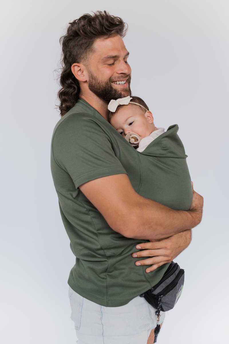 This comfortable baby carrier T-shirt provides an ergonomic infant sling for easy hands-free use by mom or dad.