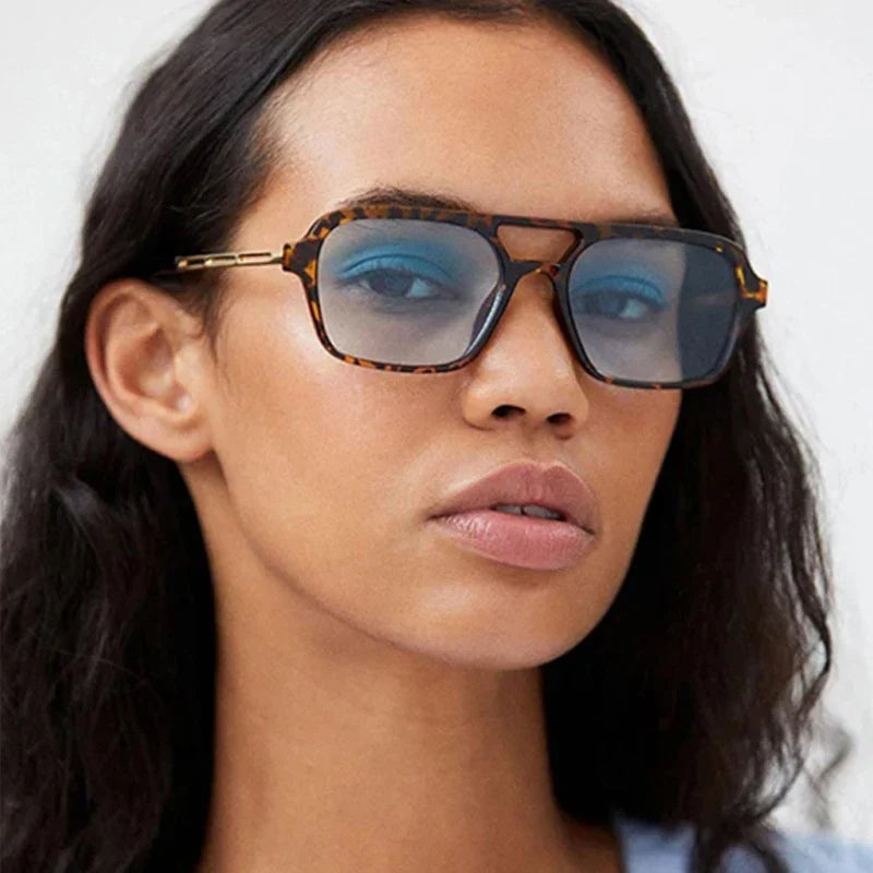 Unisex fashion sunglasses, sleek black frame, offering 100% UV protection for stylish outdoor wear.
