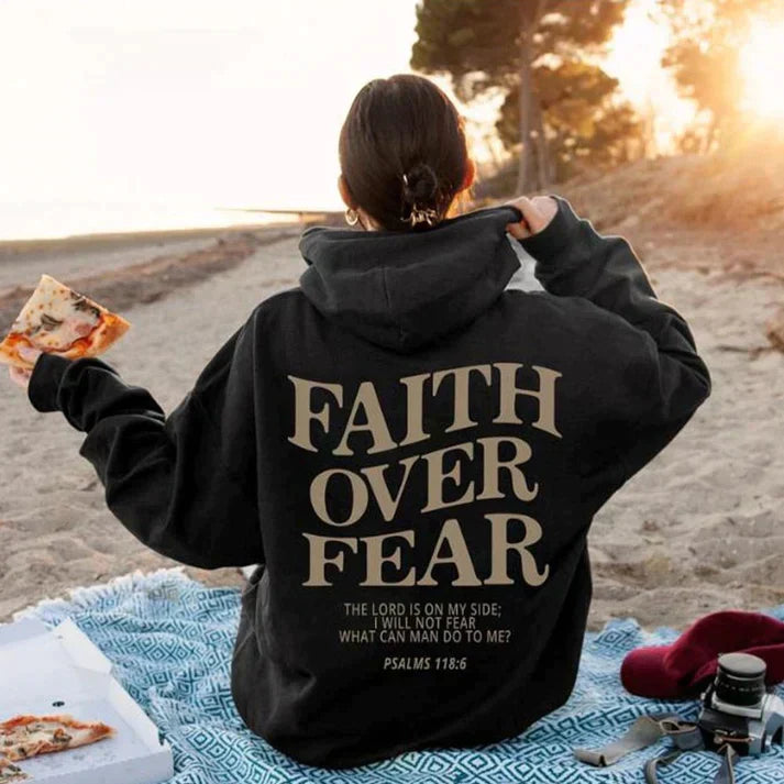 Black unisex hoodie 'Faith Over Fear' design, Psalm 118:6. Inspirational Christian apparel for comfort.