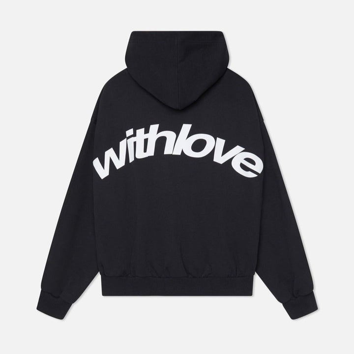 Woman wearing a cozy oversized hoodie, showcasing its comfortable fit & trendy streetwear appeal.