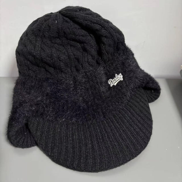 Chic knit beanie with ear flaps, suitable for any outdoor activity.