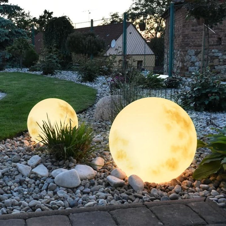 Moon-shaped USB rechargeable LED lamp for outdoor garden & patio ambiance. Decorative lunar night light.
