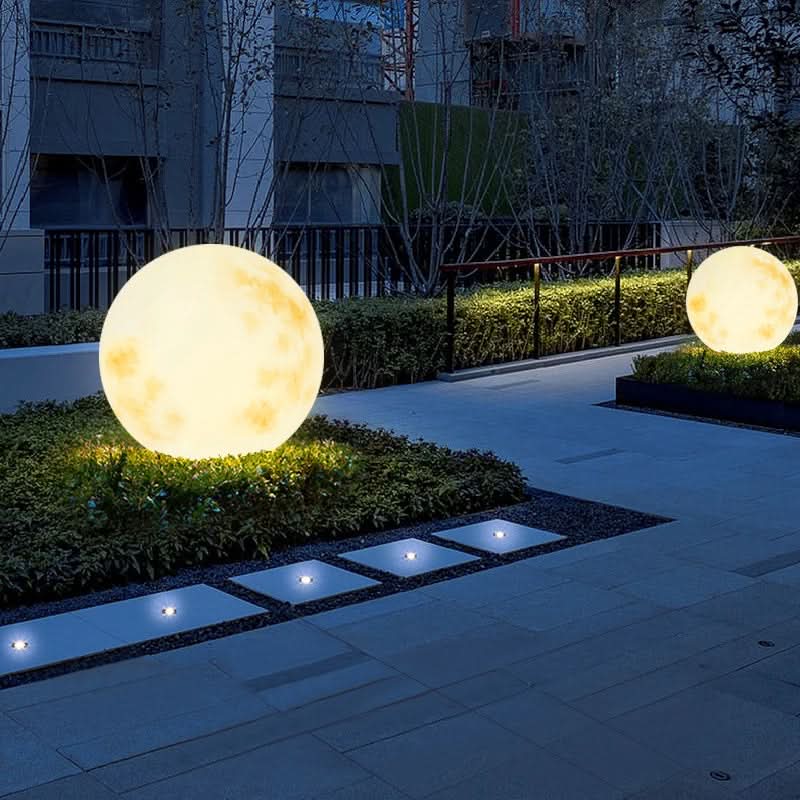 Soft glow from a decorative moon lamp. USB rechargeable LED light creating a magical garden ambiance.