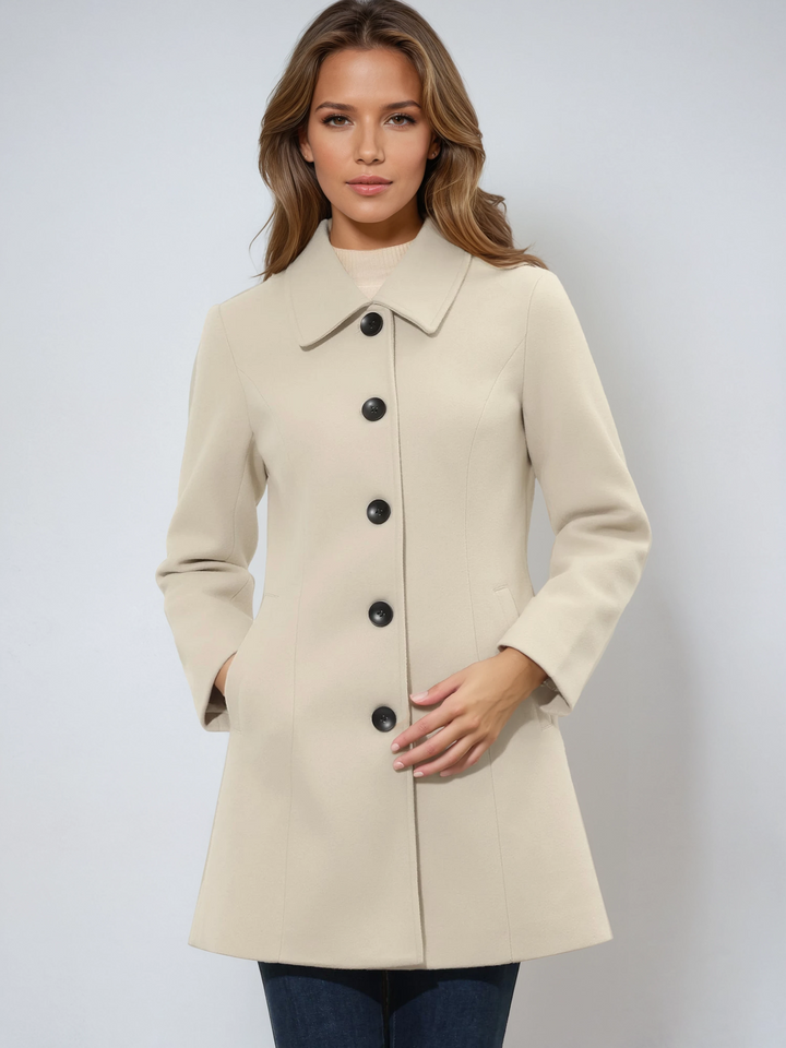 Women's sophisticated single-breasted trench coat. Elegant tailored outerwear, a versatile long jacket for winter.