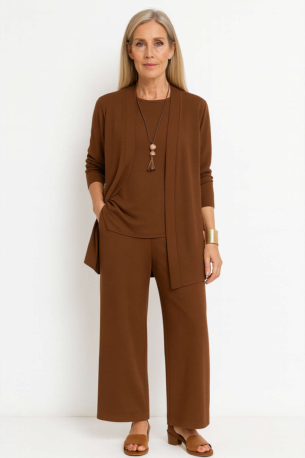 Trendy women's co-ord set featuring a long cardigan, sleeveless top, & fashionable wide leg trousers.