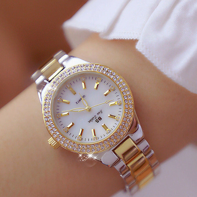 Elegant women's quartz watch with polished stainless steel case & round dial. Perfect fashion accessory for daily wear.