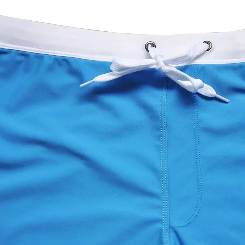 Men's quick-dry swim shorts with secure zip pocket for valuables. Perfect for beach & poolside activewear.