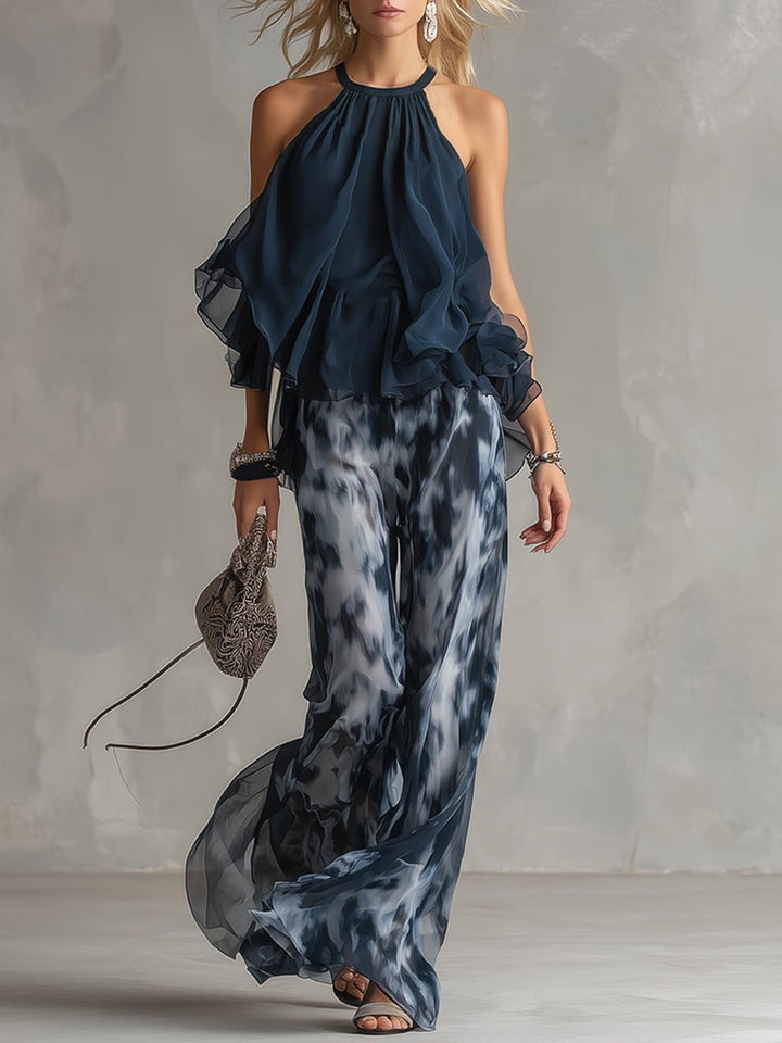 Women's navy blue halter neck top & wide leg pants two-piece set, elegant for summer vacation.