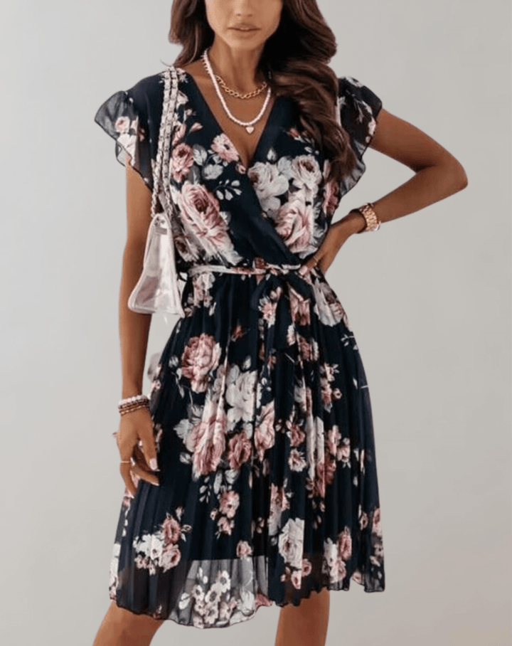 Close-up of a women's floral midi wrap dress, showcasing the vibrant print, V-neck, and flowing A-line skirt.