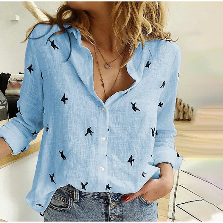 Women's refined bird print long sleeve button-up blouse. Perfect for casual or office wear.