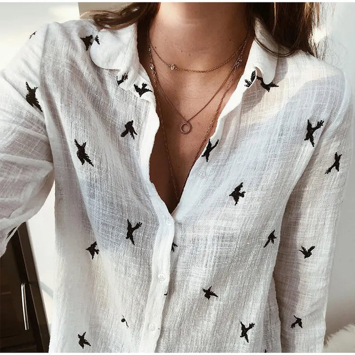 Stylish women's long sleeve blouse with elegant bird print. Button-up, versatile fashion top.