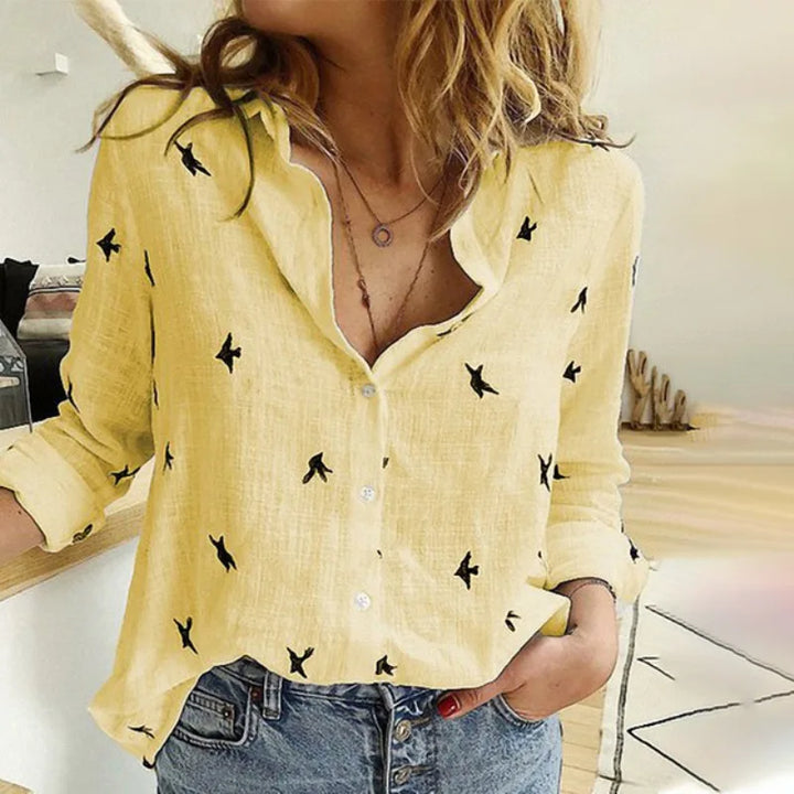 Elegant women's button-up blouse with all-over bird print. Long sleeve, perfect for office.