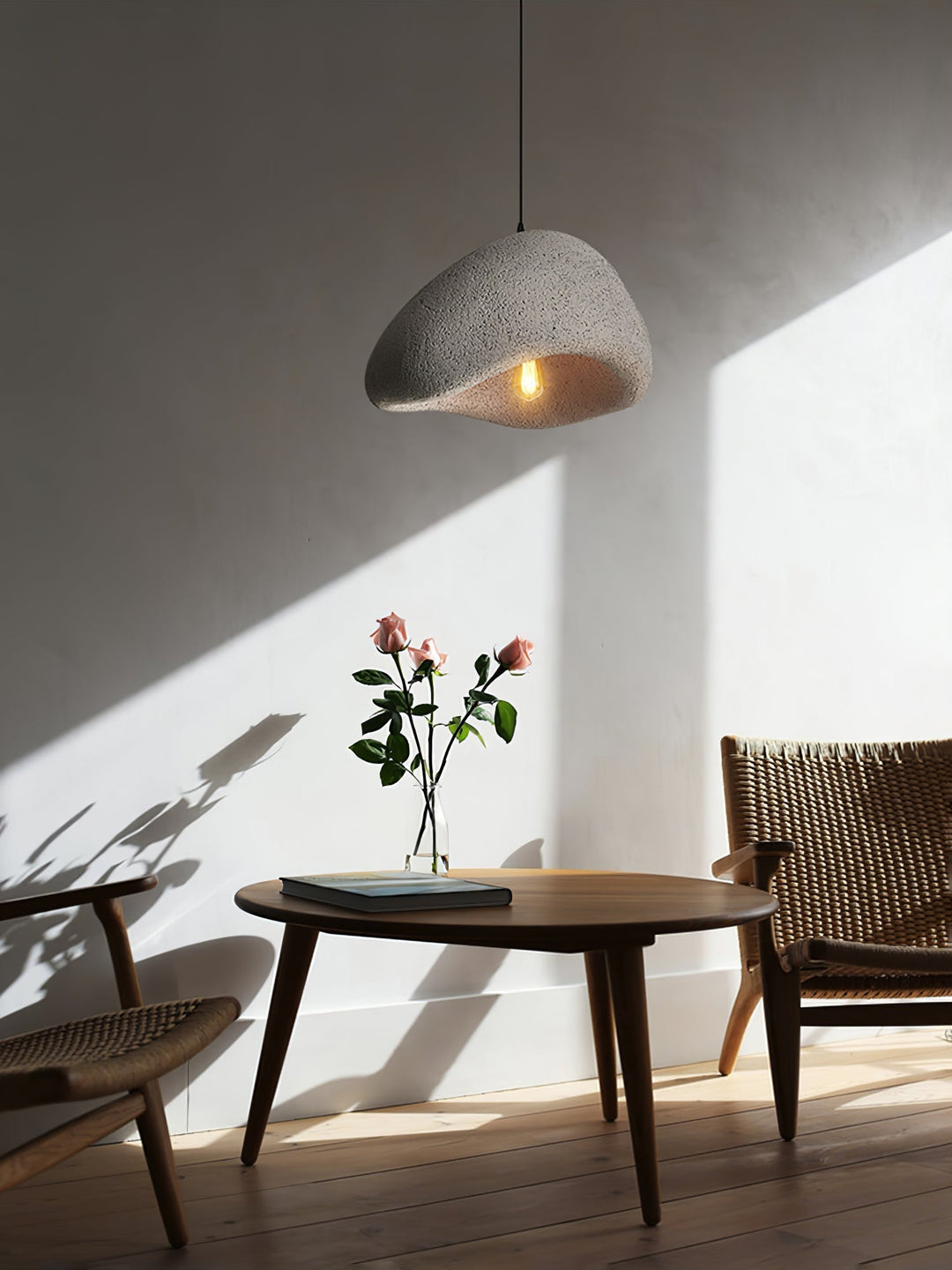 Minimalist Wabi-Sabi cocoon pendant light. Organic modern ceiling fixture offering a soft, warm glow.