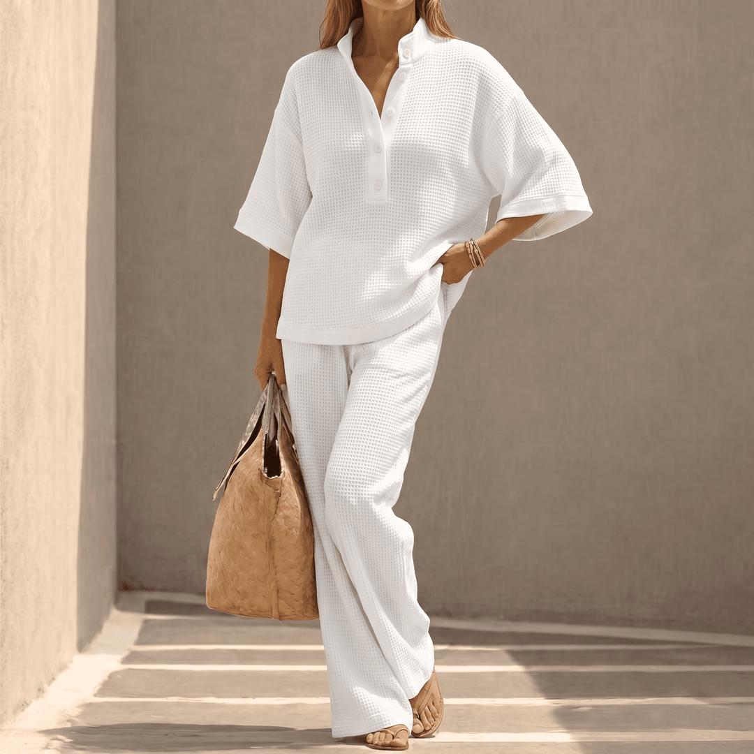 Chic women's matching waffle knit top & pants set, featuring relaxed dolman sleeves & stand collar.