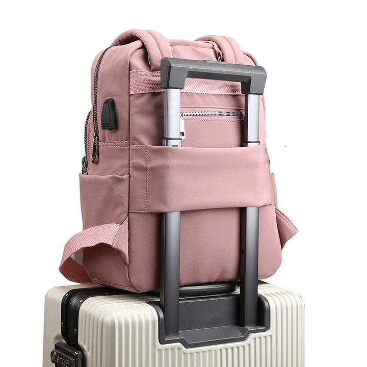 Water-resistant anti-theft backpack with USB charging port, ideal for travel.