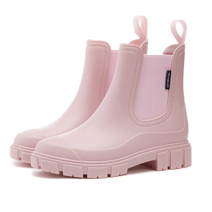 Women's stylish black waterproof Chelsea rain boots with non-slip sole for wet weather protection.