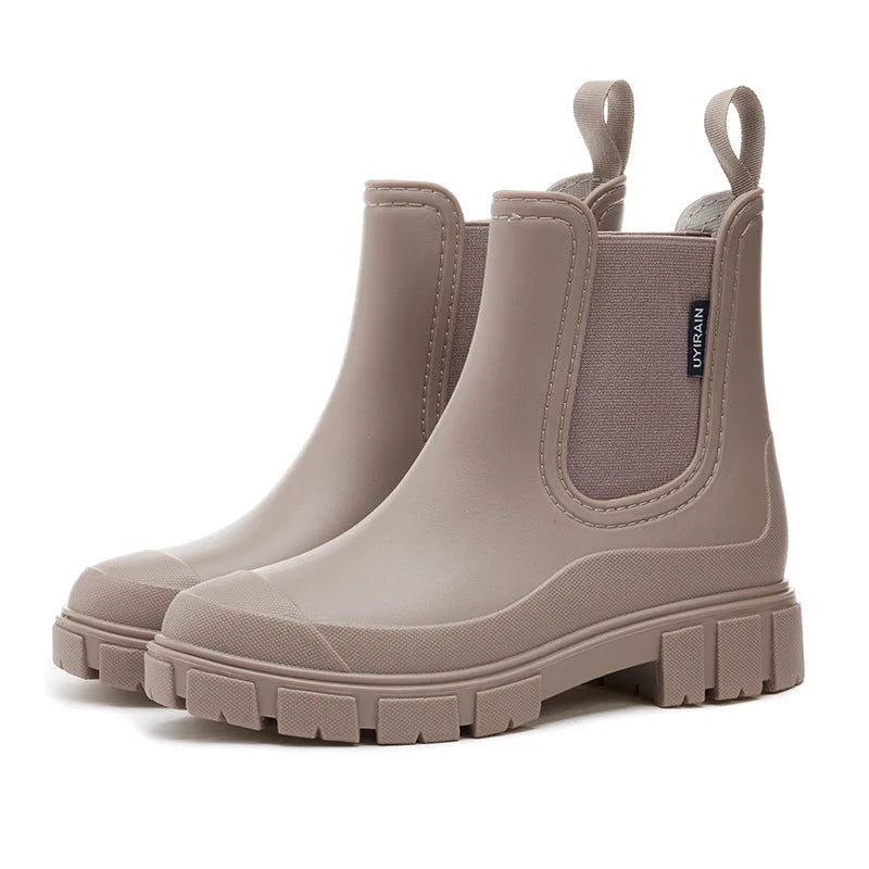 Black women's stylish waterproof Chelsea rain boots, comfortable ankle boots for all-day wear in the rain.