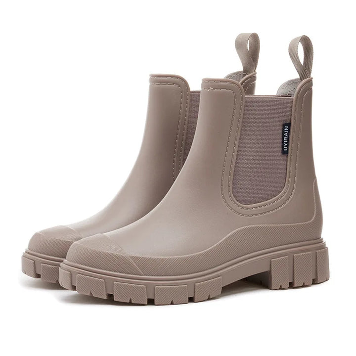 Black women's stylish waterproof Chelsea rain boots, comfortable ankle boots for all-day wear in the rain.