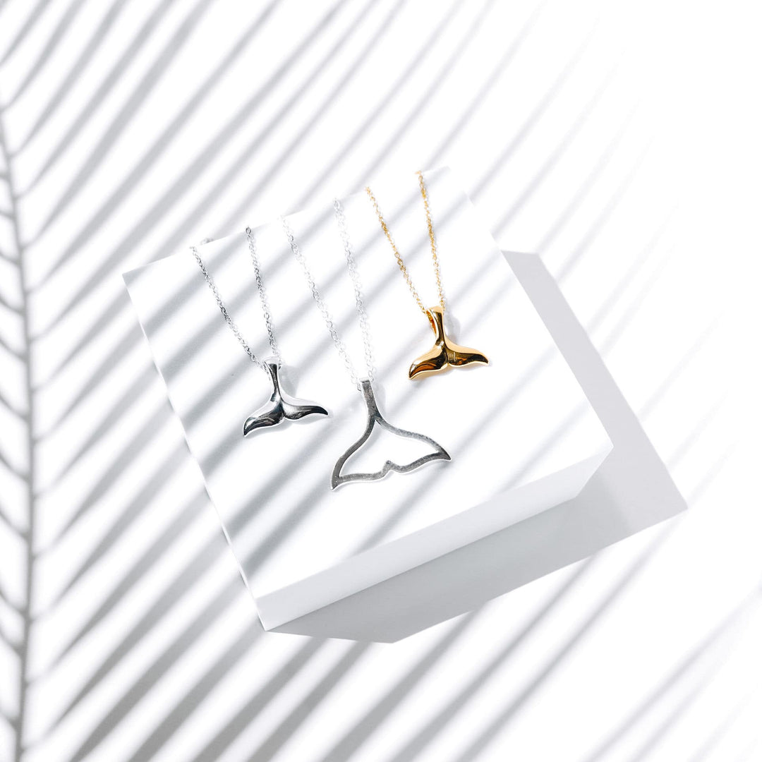 Delicate whale tail necklace in silver, elegant marine jewelry for women.