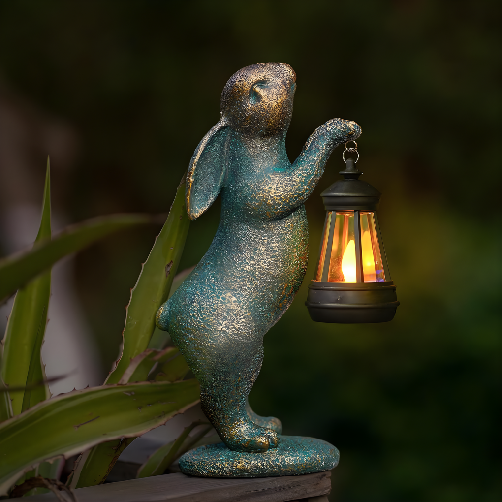 Whimsical bronze rabbit garden statue, perfect outdoor ornament & patio accent. Charming yard art for gardeners.
