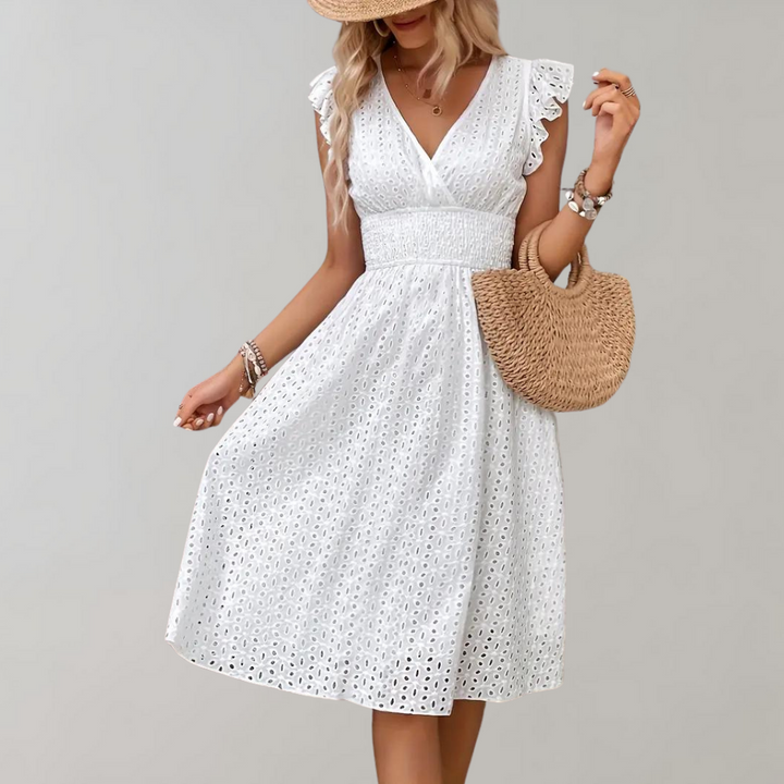 Flowy white women's summer dress featuring charming ruffled sleeves, ideal for warm weather days.