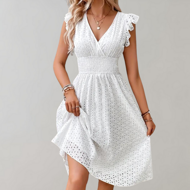 Lightweight white summer dress with stylish ruffled sleeves, offering effortless elegance and comfort.