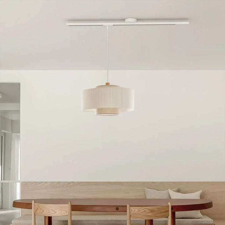 Modern adjustable ceiling light rail. White pendant system for flexible home lighting.