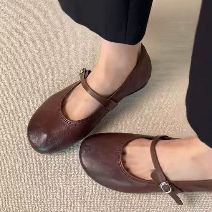 Classic brown women's Mary Jane flats with round toe & adjustable strap, great for office wear.