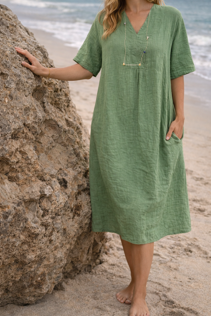Elegant pink women's V-neck midi dress with a relaxed fit, ideal for summer fashion & beachwear.