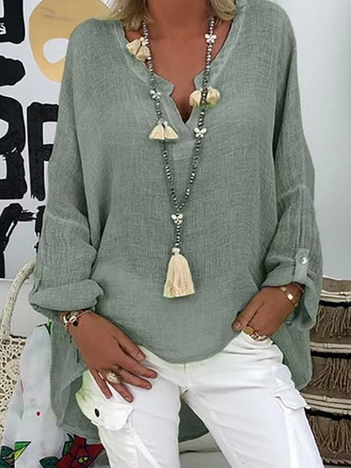 Woman modeling a comfortable, chic oversized blouse, highlighting its lightweight & flowy design.