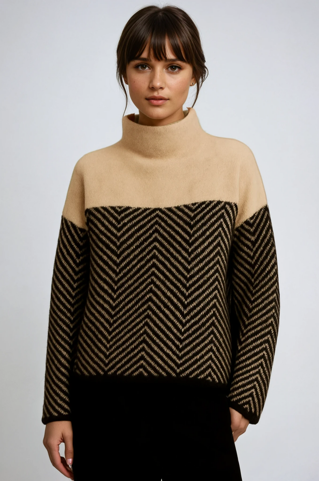 Woman wearing a stylish chevron turtleneck sweater, perfect for cozy winter fashion.