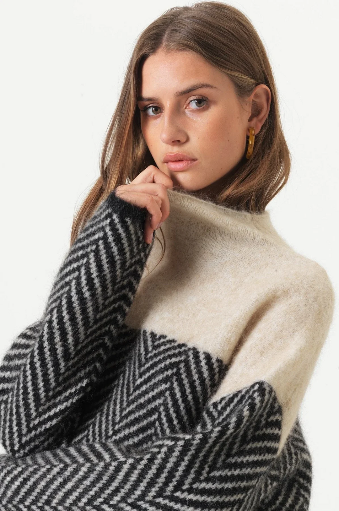 Elegant ladies' turtleneck sweater with a fashionable chevron pattern, ideal for winter.
