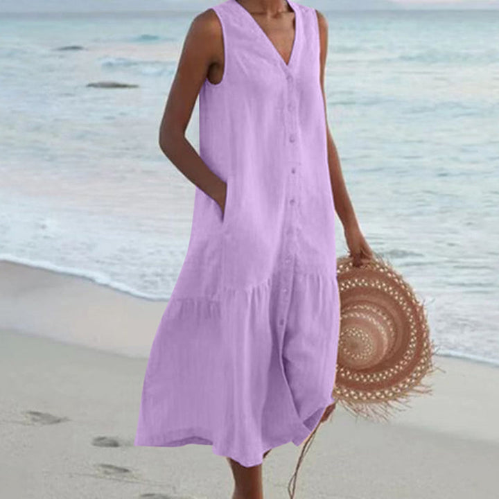 Women's sleeveless V-neck A-line midi dress featuring a button-down front and practical pockets. Elegant summer casual.