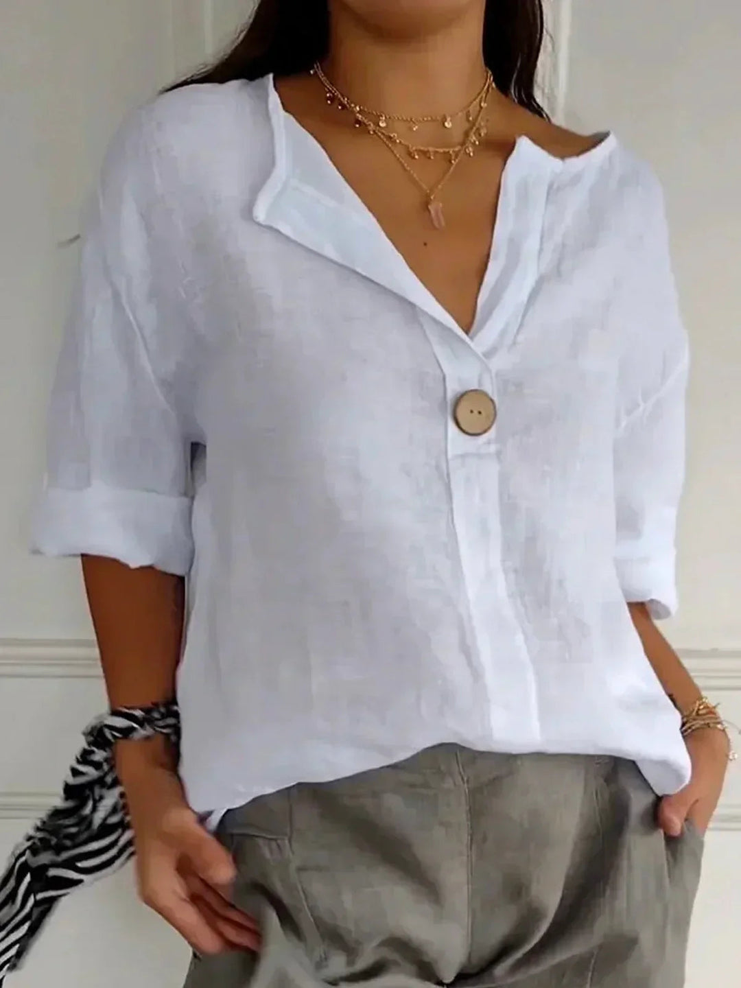 Loose fit women's button down V-neck blouse, ideal for versatile spring/summer everyday wear and relaxed elegance.