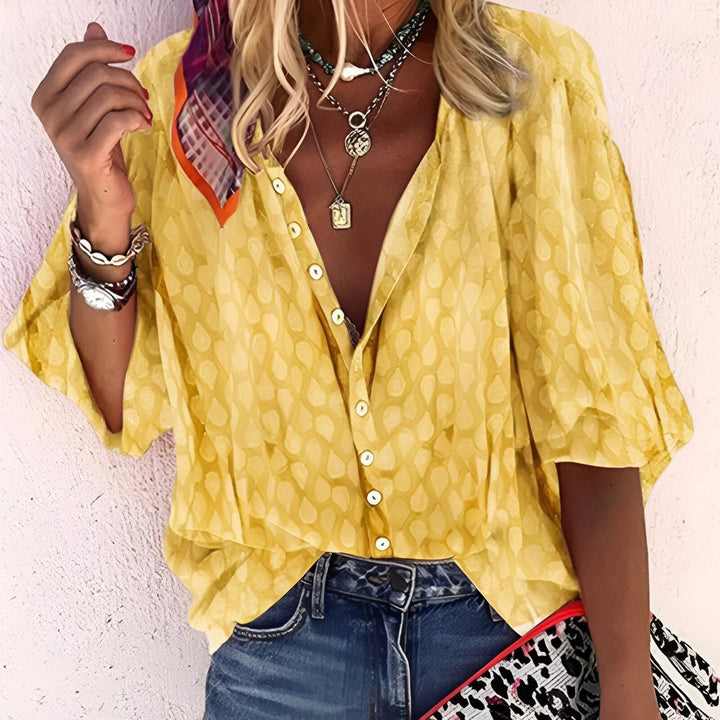 Versatile women's button-up blouse, 3/4 sleeves, relaxed comfortable fit, great for everyday elegant fashion.