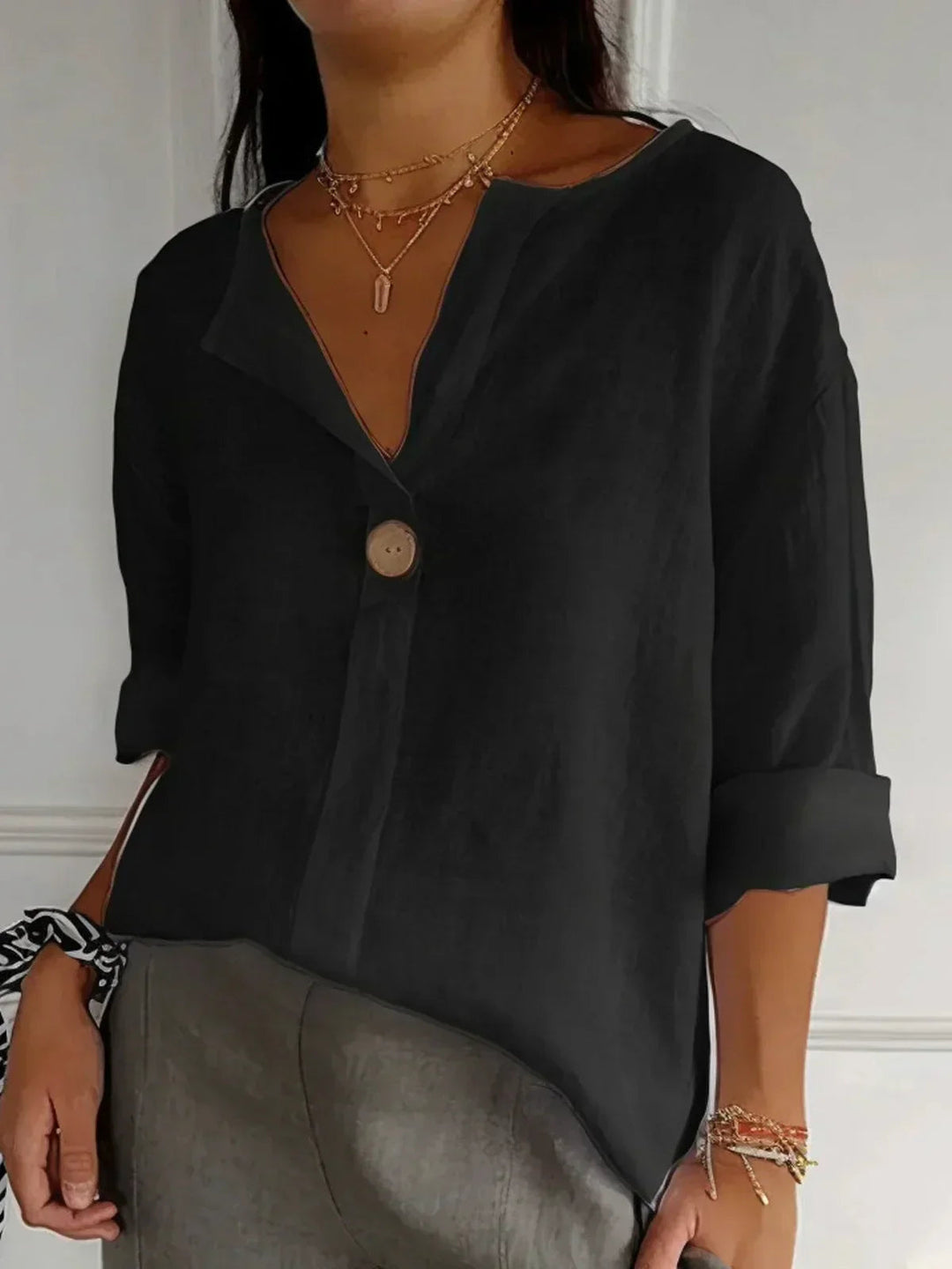 Women's relaxed fit V-neck button down blouse with 3/4 sleeves, an elegant top for versatile everyday fashion.