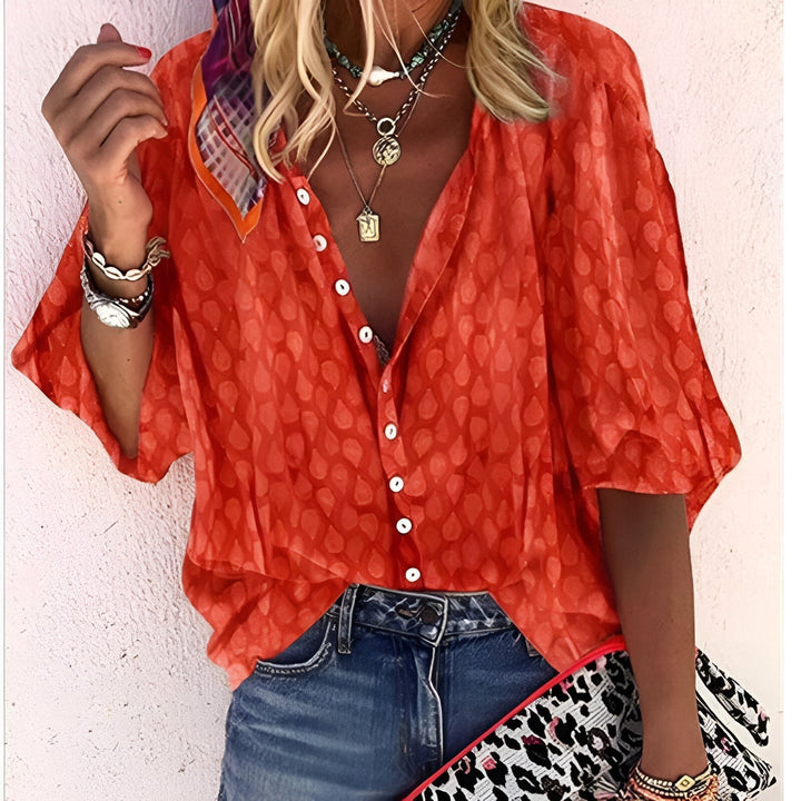 Women's relaxed fit button-up blouse featuring 3/4 sleeves and a drop shoulder for comfortable, chic style.