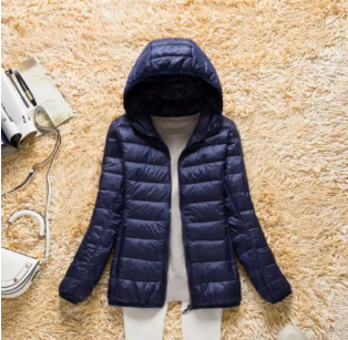 Stylish women's lightweight hooded puffer jacket, designed for comfortable everyday wear.