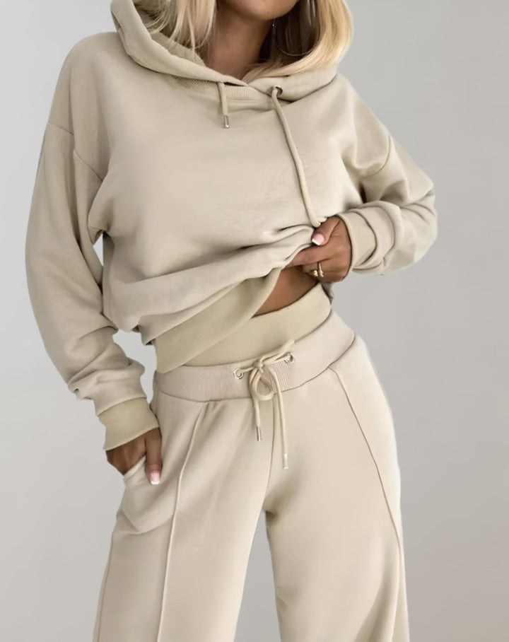 Complete women's casual set: hooded sweatshirt paired with trendy wide-leg sweatpants.