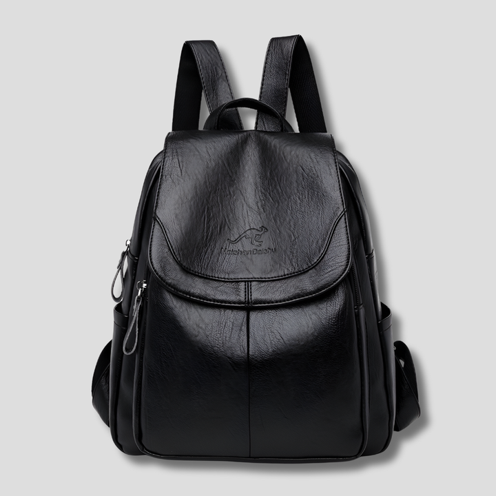 Model wearing a chic, fashion-forward women's leather backpack for work or travel.