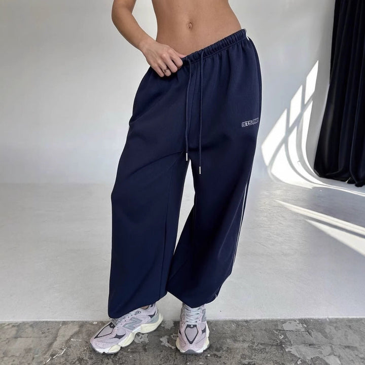 Women's baggy fit sweatpants with a stylish side stripe and adjustable drawstring.