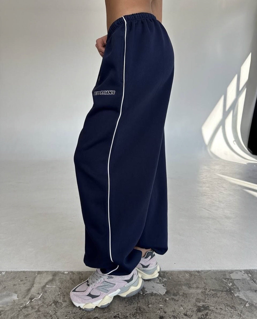 Casual wear: women's wide leg sweatpants featuring a bold side stripe.