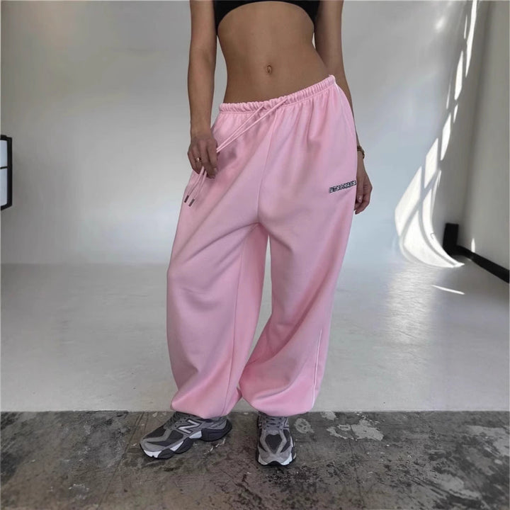 Streetwear essential: comfortable baggy fit pants with drawstring and side stripe detail.