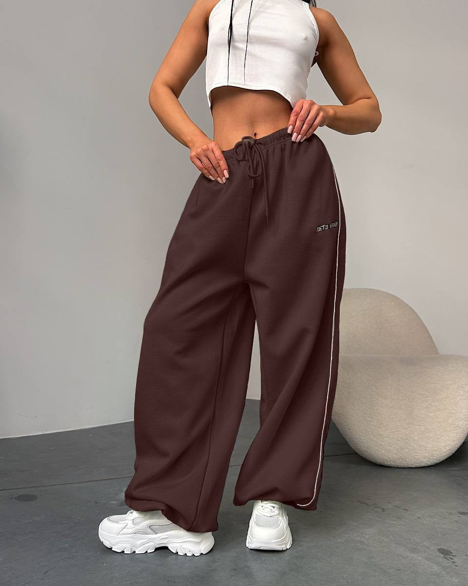 Versatile women's baggy pants with side stripe and functional drawstring for comfort.